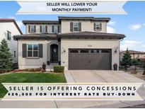 Charming two-story home featuring a well-manicured lawn, dark shutters, and a two-car garage at 9724 Cantabria Pt, Lone Tree, CO 80124