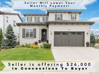 Charming two-story home with a well-manicured lawn, gray shutters, and a two car garage at 9724 Cantabria Pt, Lone Tree, CO 80124