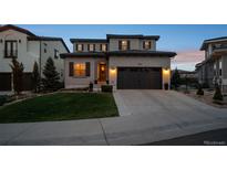 Beautifully landscaped two-story home with a two-car garage and inviting curb appeal at 9724 Cantabria Pt, Lone Tree, CO 80124