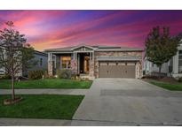 Charming single-Gathering home with a two-car garage and a stone and siding exterior at 8726 Holman Cir, Arvada, CO 80005