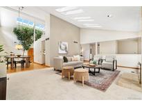 Bright living room with skylights, a cozy seating area, and an indoor tree feature at 6305 W 6Th Ave # C17, Lakewood, CO 80214