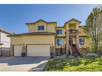 Charming home with a lush lawn, beautiful landscaping, and a cozy second story porch at 10703 Flagler Dr, Parker, CO 80134