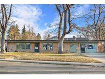 Ranch-style home with mature trees and a well-maintained lawn at 6440 - 6450 W 35Th Ave, Wheat Ridge, CO 80033