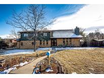 Charming two-story brick home with a manicured front yard and walkway leading to the front door at 13852 W 54Th Ave, Arvada, CO 80002