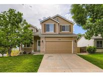 Charming two-story home with a well-manicured lawn, inviting curb appeal, and a two car garage at 11363 Latigo Ln, Parker, CO 80138