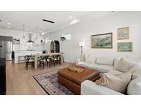 Bright, open-concept living and dining area with hardwood floors and stylish decor at 1250 W Osceola St # 2, Denver, CO 80204