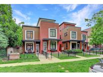 Modern exterior elevation showcasing brick, siding, and a well-maintained front yard with a black metal fence at 2138 N Glenarm Pl, Denver, CO 80205
