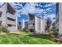 Stylish condo exterior with modern architecture, lush green lawns, and beautiful landscaping at 9837 E Peakview Ave # 7, Englewood, CO 80111