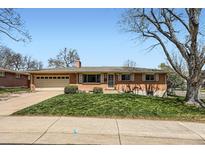Charming brick home with a well-maintained lawn and an attached two-car garage at 6773 E Baker Pl, Denver, CO 80224