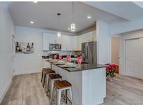 Modern kitchen with island, stainless steel appliances, and ample counter space at 14936 E Hampden Ave # 202, Aurora, CO 80014