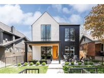 Striking two-story home features a modern black and white design, complemented by a beautifully landscaped front yard at 732 S Gaylord St, Denver, CO 80209