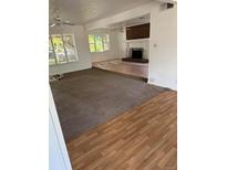 Spacious living room with abundant natural light, and a cozy fireplace at 938 Salem St, Aurora, CO 80011