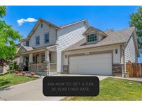 Charming two-story home with a well-manicured lawn and attached two-car garage on a sunny day at 11256 Lima St, Commerce City, CO 80640