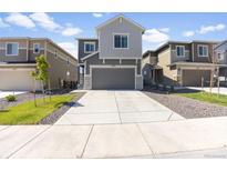Charming two-story home featuring a gray exterior, well-manicured lawn and a two-car garage at 16423 Mountain Flax Dr, Monument, CO 80132