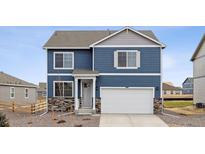 Charming two-story home with a mix of blue siding and stone accents at 779 N Deer Park St, Watkins, CO 80137