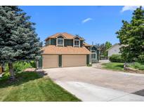 Charming two-story home with attached three-car garage and mature landscaping at 603 E 2Nd Ave, Castle Rock, CO 80108