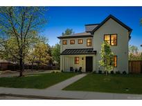 Charming two-story home featuring a well-manicured lawn, modern design, and inviting front porch at 1195 S Milwaukee St, Denver, CO 80210