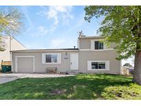 Charming two-story home featuring a well-maintained lawn, attached garage, and freshly painted exterior at 10405 W 107Th Pl, Broomfield, CO 80021