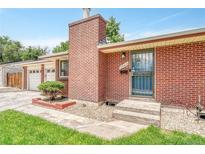 Charming red brick home featuring a well-kept lawn and a welcoming front entrance at 3463 W Bowles Ave, Littleton, CO 80123