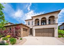 Beautiful stucco home featuring a tile roof and a three-car garage at 2264 S Joyce St, Lakewood, CO 80228