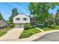 Charming two-story home with a well-maintained yard and inviting curb appeal on a sunny day at 6979 E Fremont Ave, Centennial, CO 80112