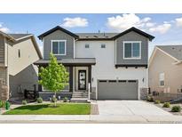 Charming two-story home with gray and white siding, a two-car garage, and a manicured front lawn at 81 Simmental Loop, Castle Rock, CO 80104