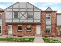 Charming brick townhouse featuring Tudor-style accents and a well-manicured front lawn at 677 Vrain St # 10, Denver, CO 80204