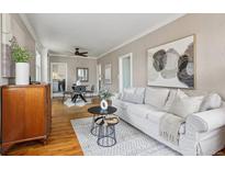 Bright living room boasts hardwood floors, neutral walls, and stylish furnishings, creating a warm and inviting space at 4883 Perry St, Denver, CO 80212