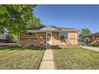 Charming brick home with a well-maintained front yard and inviting walkway, perfect for suburban living at 7060 Avrum Dr, Denver, CO 80221