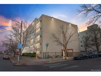 Exterior view of a multi-story building featuring modern architecture and well-maintained landscaping at 1390 N Emerson St # 106, Denver, CO 80218