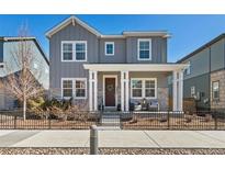 Charming two-story home boasts a welcoming front porch and stylish gray siding at 9080 W 100Th Way, Broomfield, CO 80021