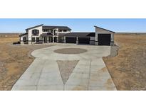 Stunning two-story home featuring a circular driveway and modern design at 12450 Watkins Rd, Hudson, CO 80642