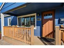 Charming blue home featuring a covered front porch, a welcoming front door, and a well-manicured entrance at 1390 S Glencoe St, Denver, CO 80222
