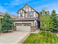 Charming two-story home featuring a two-car garage, classic tudor detailing, and a well-manicured front yard at 2833 Open Sky Way, Castle Rock, CO 80109