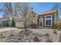 Charming home with a well-maintained front yard, decorative tree, and rock landscaping at 19624 E Girard Dr, Aurora, CO 80013