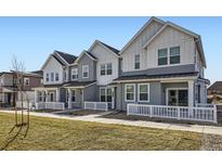 Charming townhomes featuring modern architecture and a well-manicured lawn at 14587 W 90Th Ln # B, Arvada, CO 80005
