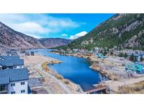 Beautiful aerial view of a neighborhood nestled in the mountains with a blue river running through it on a sunny day at 1890 Argentine St # C301, Georgetown, CO 80444
