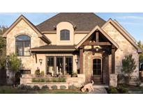 Beautiful stone and brick home with a charming front porch and manicured landscaping at 2260 S Jackson St, Denver, CO 80210