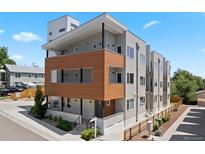 Modern gray exterior with a wood accent wall and a private balcony, located in a vibrant neighborhood at 1256 Xavier St, Denver, CO 80204