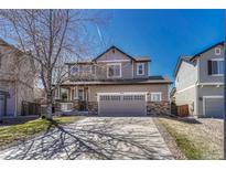 Charming two-story home featuring stone accents, a spacious two-car garage, and a well-manicured front lawn at 2976 Open Sky Way, Castle Rock, CO 80109