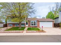 Charming two-story home featuring a landscaped front yard, brick accents, and an attached two-car garage at 18472 E Atlantic Dr, Aurora, CO 80013
