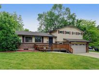 Inviting two-story home with a charming front deck and well-manicured lawn at 800 Mesa Ct, Broomfield, CO 80020