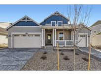 Charming two-story home with a covered porch, two-car garage, and manicured front yard at 39876 Floyd St, Elizabeth, CO 80107