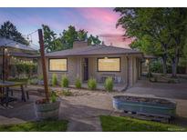 Charming single-story home with a landscaped front yard and patio seating area at 13211 W 32Nd Ave, Golden, CO 80401