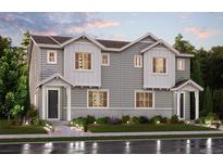 Inviting two-story home featuring charming curb appeal, manicured lawn, and covered front entrance at 14129 Deertrack Ln, Parker, CO 80134