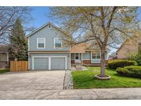 Charming two-story home with a well-manicured lawn and a two-car garage in a desirable neighborhood at 11908 W Aqueduct Dr, Littleton, CO 80127