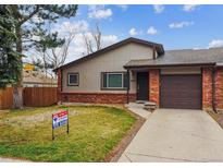Cozy single-Gathering home featuring brick accents, a driveway, a well-maintained lawn and mature trees at 444 S Larkspur Dr, Castle Rock, CO 80104
