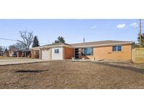 Charming brick home featuring a spacious front yard and an attached two-car garage at 951 E 10Th Ave, Broomfield, CO 80020