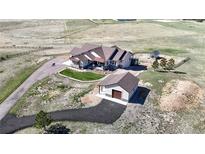 Expansive property featuring a custom home, detached garage, and picturesque views of the surrounding landscape at 220 High Meadows Loop, Elizabeth, CO 80107
