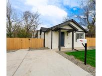 Charming home featuring a well-manicured lawn, convenient driveway, and a classic mailbox, offering curb appeal at 1450 Syracuse St, Denver, CO 80220